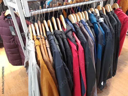 clothes on hangers lined up neatly  