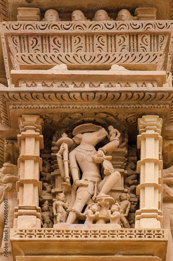 Stone carved sculptures on the outer wall of the Devi Jagdamba temple, Western group of monuments, Khajuraho, Madhya Pradesh, India, Asia.