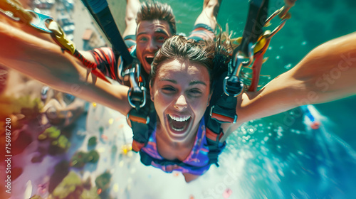 Woman and a man are bungee jumping together.  They are happy and smiling
