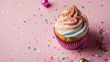 Birthday cupcake composition against a pink backdrop Text space available