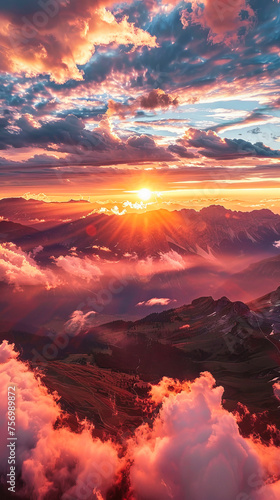 An aerial view of a spectacular sunset over the mountains, with spectacular clouds