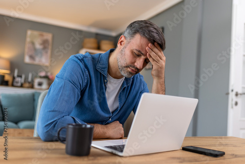 Businessman office working holding sore head pain from desk working and sitting all day using laptop computer or notebook suffering headache sick worker overworking concept
