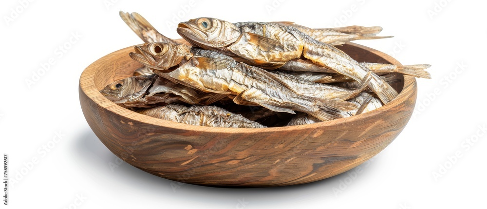 Dried fish in wooden bowl on white background Dried fish in wooden bowl on white background