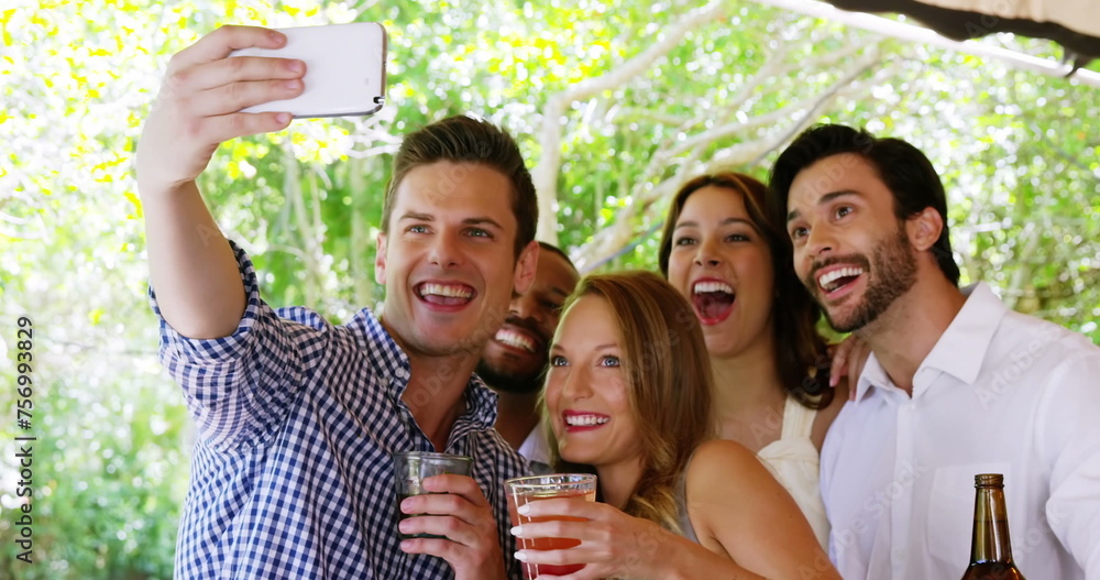 Obraz premium Emoji icons fly as diverse friends take a selfie at a party in 4k.
