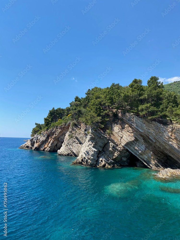 Turquoise Cove: Rugged Cliffs, Lush Pines