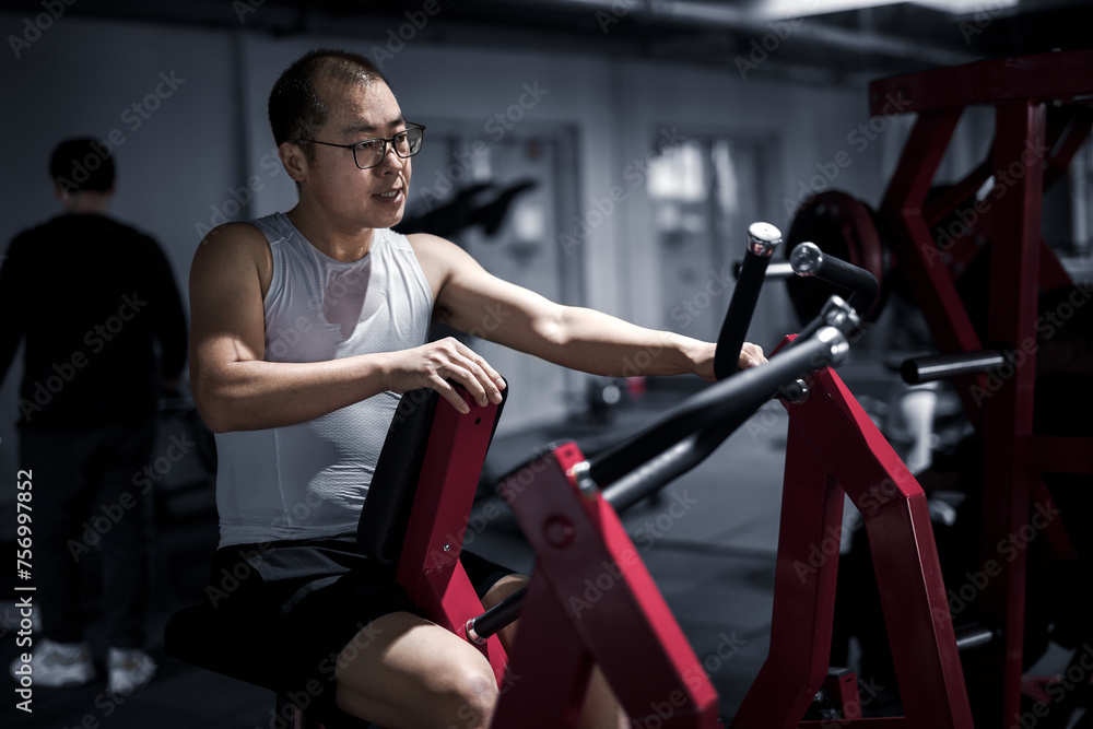 Men exercise their arm muscles in the gym Men exercise their arm muscles in the gym