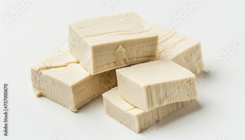 Slice uncooked tofu on plain surface