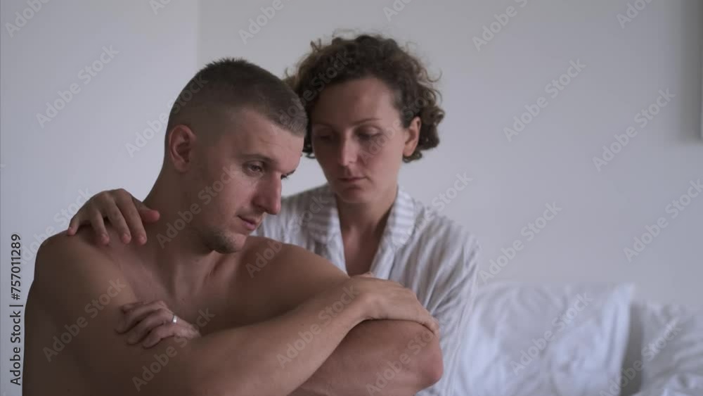Naked man and woman are on rumpled bed think about problem of sexual health. Man is upset about his sexual health problem woman pressed her forehead against his shoulder. Concept men sexual health Naked man and woman are on rumpled bed think about problem of sexual health. Man is upset about his sexual health problem woman pressed her forehead against his shoulder. Concept men sexual health