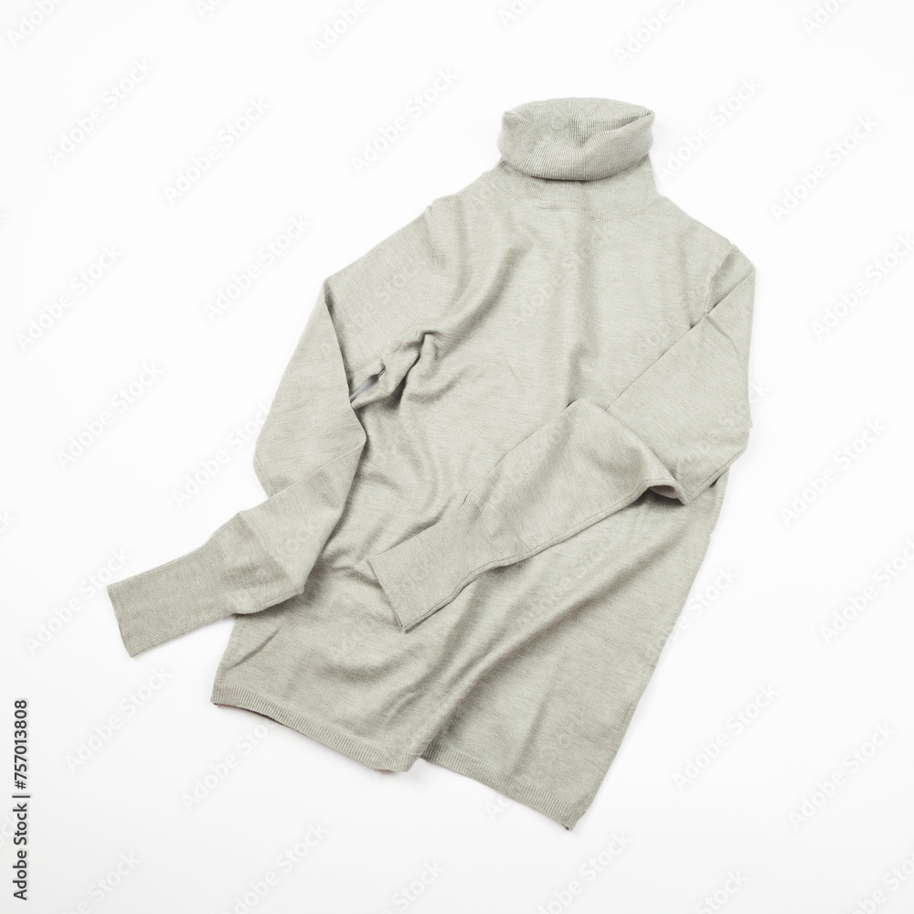 Beautiful female luxurious woolen grey knitted wool turtleneck sweater, top view, isolated on white background Beautiful female luxurious woolen grey knitted wool turtleneck sweater, top view, isolated on white background