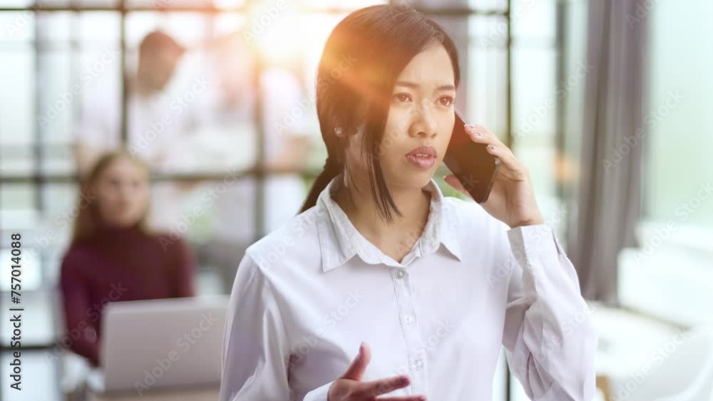 Young Asian woman talking on mobile phone with happily. Young Asian woman talking on mobile phone with happily.