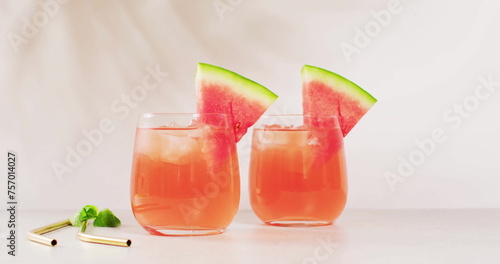 Two glasses of watermelon juice are on display, with copy space