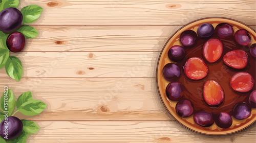 Tart or pie with plums and plum halves on wooden 