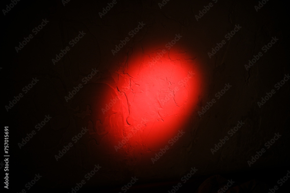 Abstract red circle spotlight on wall. Background with optical lens flares light shine ray, copy space Abstract red circle spotlight on wall. Background with optical lens flares light shine ray, copy space