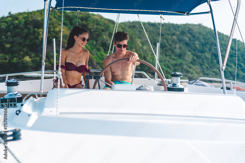 A couple is sitting on a boat in the ocean