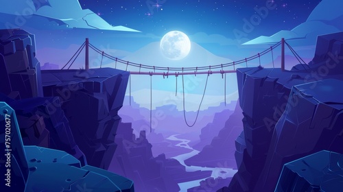 During the evening, a rope bridge hangs between the edges of a dangerous cliff with a gap chasm in the distance. An evening cartoon landscape shows an adventure footbridge over a canyon in the photo