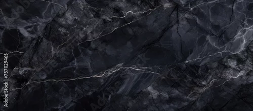 Panel kuchenny z motywem A detailed shot showcasing the intricate patterns and layers of a black marble texture, resembling a rugged natural landscape with hints of bedrock and rock formations