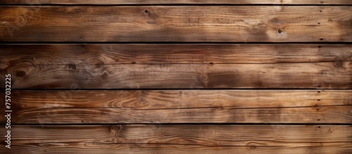 A closeup shot of a brown hardwood plank wall with beige tints and shades, resembling brickwork. The blurred background enhances the texture and detail of the wood
