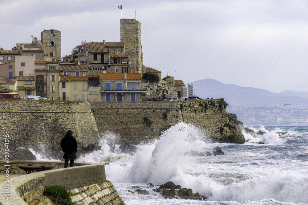 Man gazing at storm, old town, waves, Antibes. High quality photo