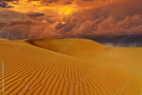Dramatic sunset over the sand dunes in the desert. Namib desert.