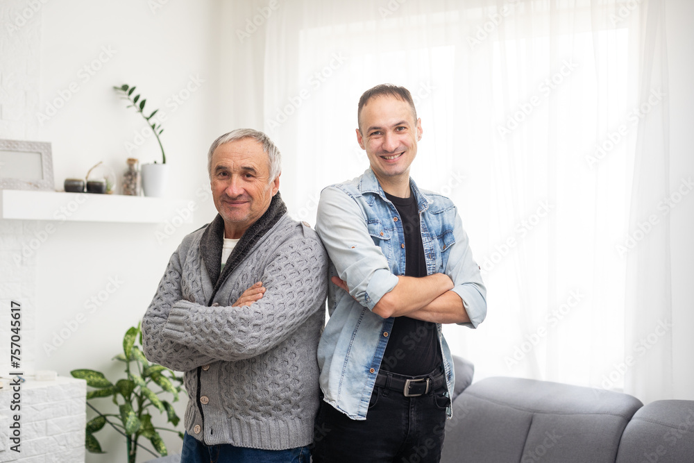 Portrait of happy smiling father and his adult son. Man hugging his elderly father. Father's day concept. Portrait of happy smiling father and his adult son. Man hugging his elderly father. Father's day concept.