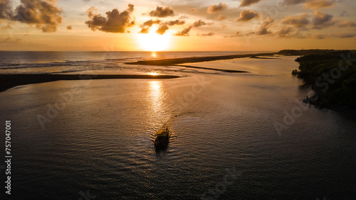 the aerial view  the boats sailing in the lagoon at sunset looks very beautiful.