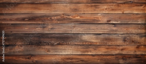 Close up of a rectangular hardwood plank wall with a brown wood stain, showcasing the beautiful pattern of the building material