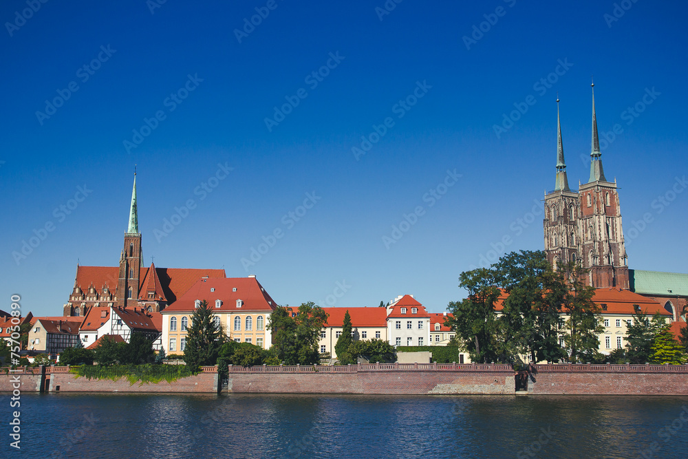 Wroclaw city in Poland. Polish urban cityscape. Odra river flowing through the city scenter. Old town tower. Breslau famous scenery.