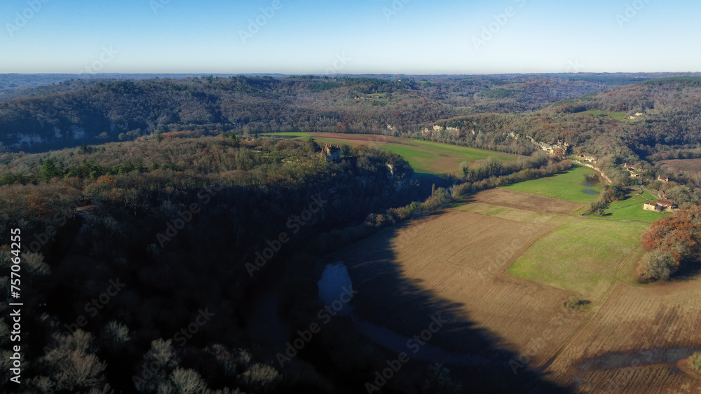 High-altitude drone photo of the Vézère Valley with the Château de Marzac, the troglodytic village of La Madeleine in Tursac and the Dordogne River.