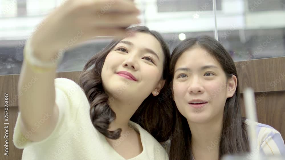Two happy Asian girls talking with friends on video call. Stylish young Asian woman sitting on chair drinking and eating bread in cafe. female using smart phone talking on video call with friends
Two happy Asian girls talking with friends on video call. Stylish young Asian woman sitting on chair drinking and eating bread in cafe. female using smart phone talking on video call with friends