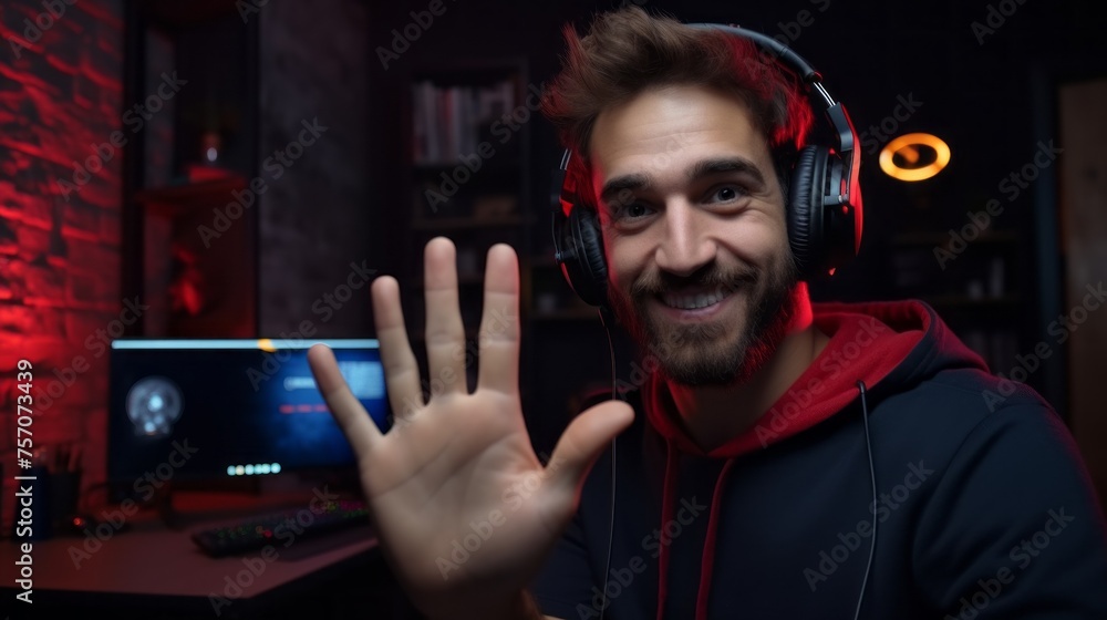 A bearded video blogger, a Man, a professional streamer gamer waves at the camera, greets his subscribers, conducts a live broadcast of a video game on a computer at home. Esports, technology, Hobby. A bearded video blogger, a Man, a professional streamer gamer waves at the camera, greets his subscribers, conducts a live broadcast of a video game on a computer at home. Esports, technology, Hobby.