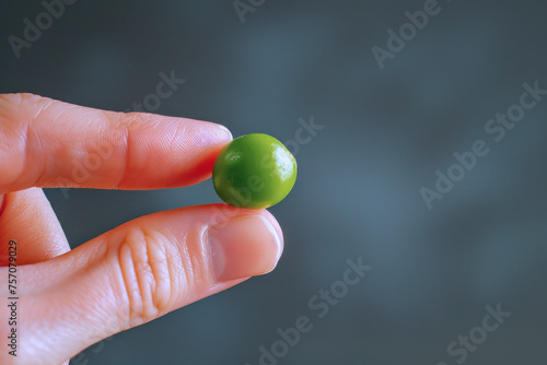 Hand holding green pea isolated with copy space, healthy food