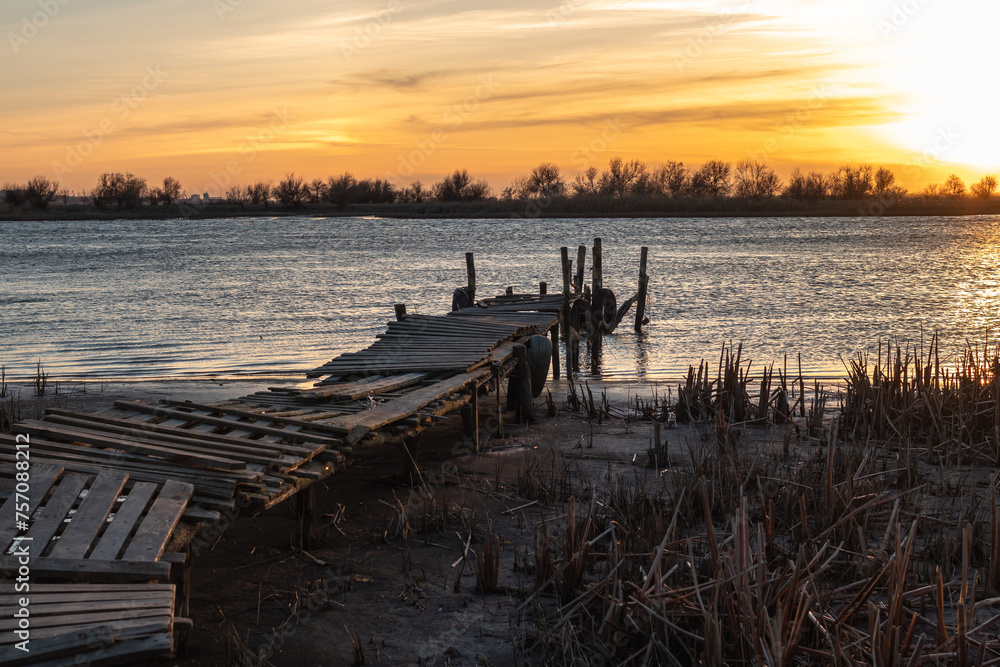 View of the ruins of an old pier during sunset
