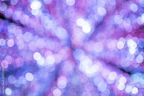 Celebration lights at Christmas New Year festival. Crowd of hanging blue light bulbs blue bokeh background. blue light bulb tunnel. 
