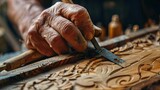 Sculptor hand working with wood carving with chisel making sculpture.