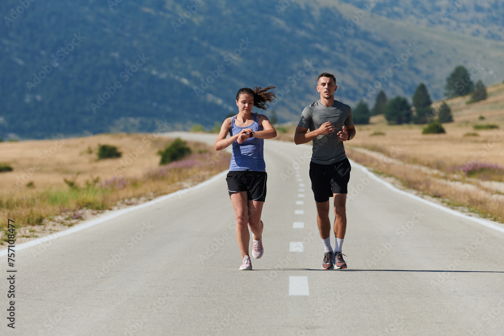 Fototapeta premium Energized by the beauty of nature, a couple powers through their morning run, their bodies and spirits invigorated.
