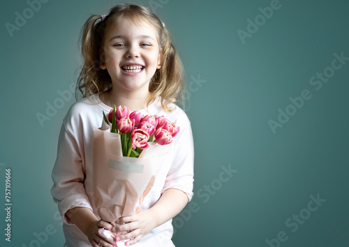 Caucasian child girl holiding tulips bouquet empty copy space background.Mother's day. Women's day. Spring time greeting card.