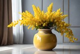 Bouquet of yellow mimosa flowers in ceramic vase