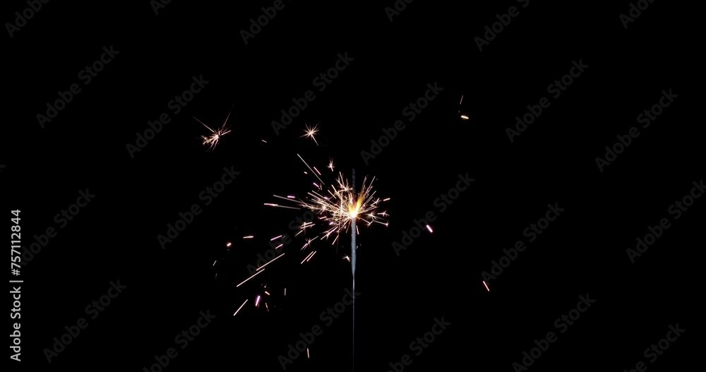 Lightening sparkler on the black background. Sparkler concept. Bengal lights are burning on a black background. Holiday party concept. New year party sparkler. Lightening sparkler on the black background. Sparkler concept. Bengal lights are burning on a black background. Holiday party concept. New year party sparkler.