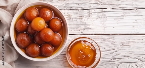 Top view of delicious gulab jamuns served with an indian drink on a white wooden table, holi photo