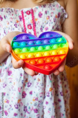 Girl holding heart shaped pop it toy