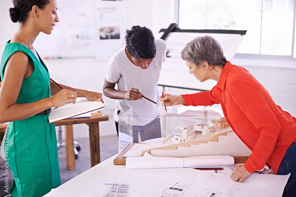 Model, floor plan or engineering team drawing for development project or planning on paper. Architecture, women or group of designers with collaboration for innovation or blueprint of office building Model, floor plan or engineering team drawing for development project or planning on paper. Architecture, women or group of designers with collaboration for innovation or blueprint of office building