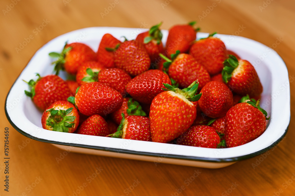 Fruit, food and strawberry bowl in kitchen of home, on wooden counter top for diet or nutrition. Health, wellness and lose weight with berries on surface in apartment for detox, minerals or vitamins Fruit, food and strawberry bowl in kitchen of home, on wooden counter top for diet or nutrition. Health, wellness and lose weight with berries on surface in apartment for detox, minerals or vitamins