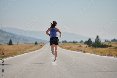 A determined woman athlete trains for success in the morning sun.
