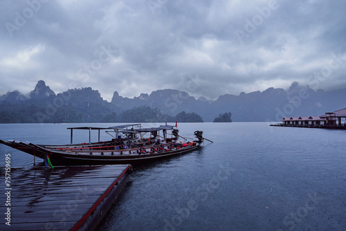 Traditional wooden boats on wharf in Cheow Lan Lake, Khao sok national park, Thailand. photo