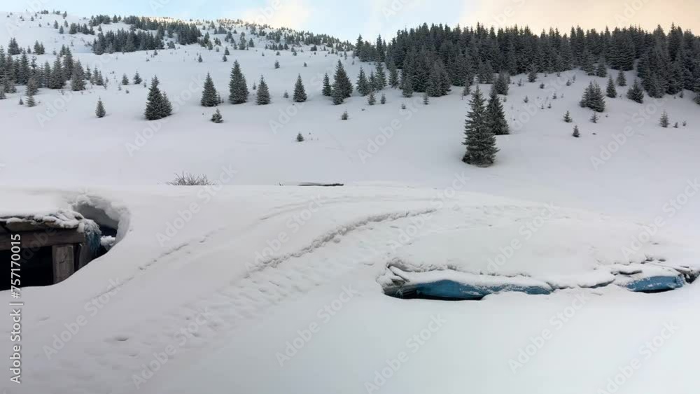 So much snow has fallen on an alpine pasture in the Carpathians, Ukraine, that all-terrain vehicles are driving right on the roof of a barn. So much snow has fallen on an alpine pasture in the Carpathians, Ukraine, that all-terrain vehicles are driving right on the roof of a barn.