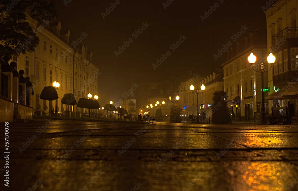 Street in the night with street lamps, after the rain