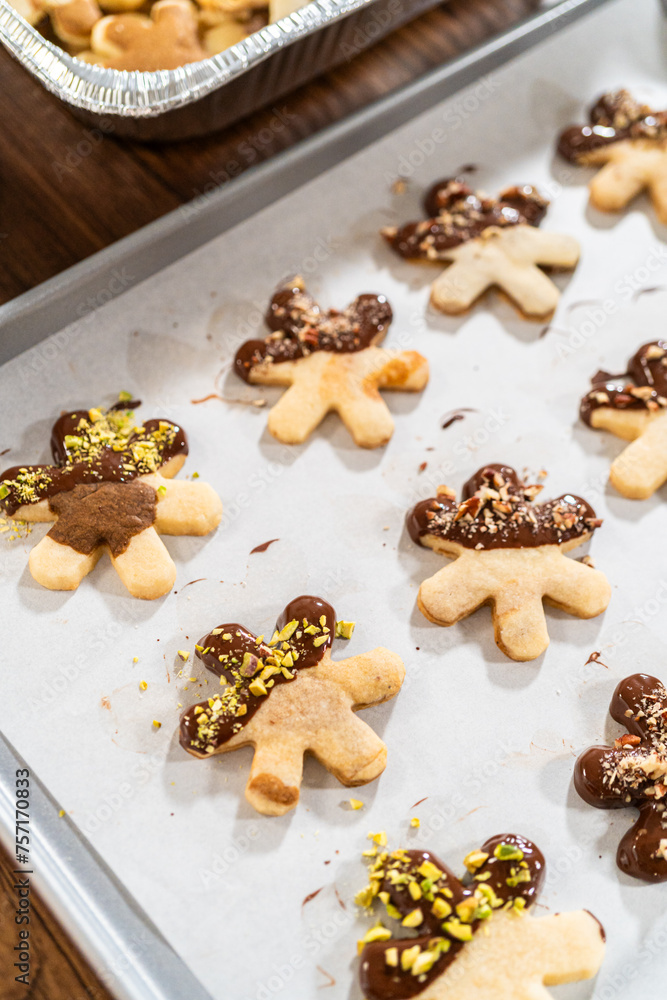 Fototapeta premium Making Holiday Star Cookies, Chocolate-Dipped with Pistachio Topping