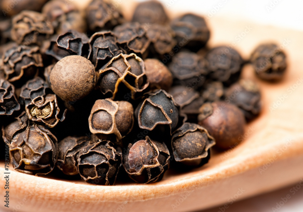 Black peppercorns on a spoon Black peppercorns on a spoon