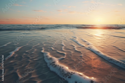 a beach with sand patterns  with the sun setting in the distance and its reflection on the water s surface  the colors of the sky and the sea blending together in a mesmerizing way