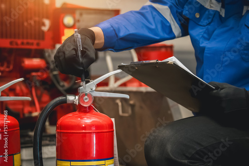 Billede på lærred Engineer check fire extinguisher tank in the fire control room for safety in factory or industry